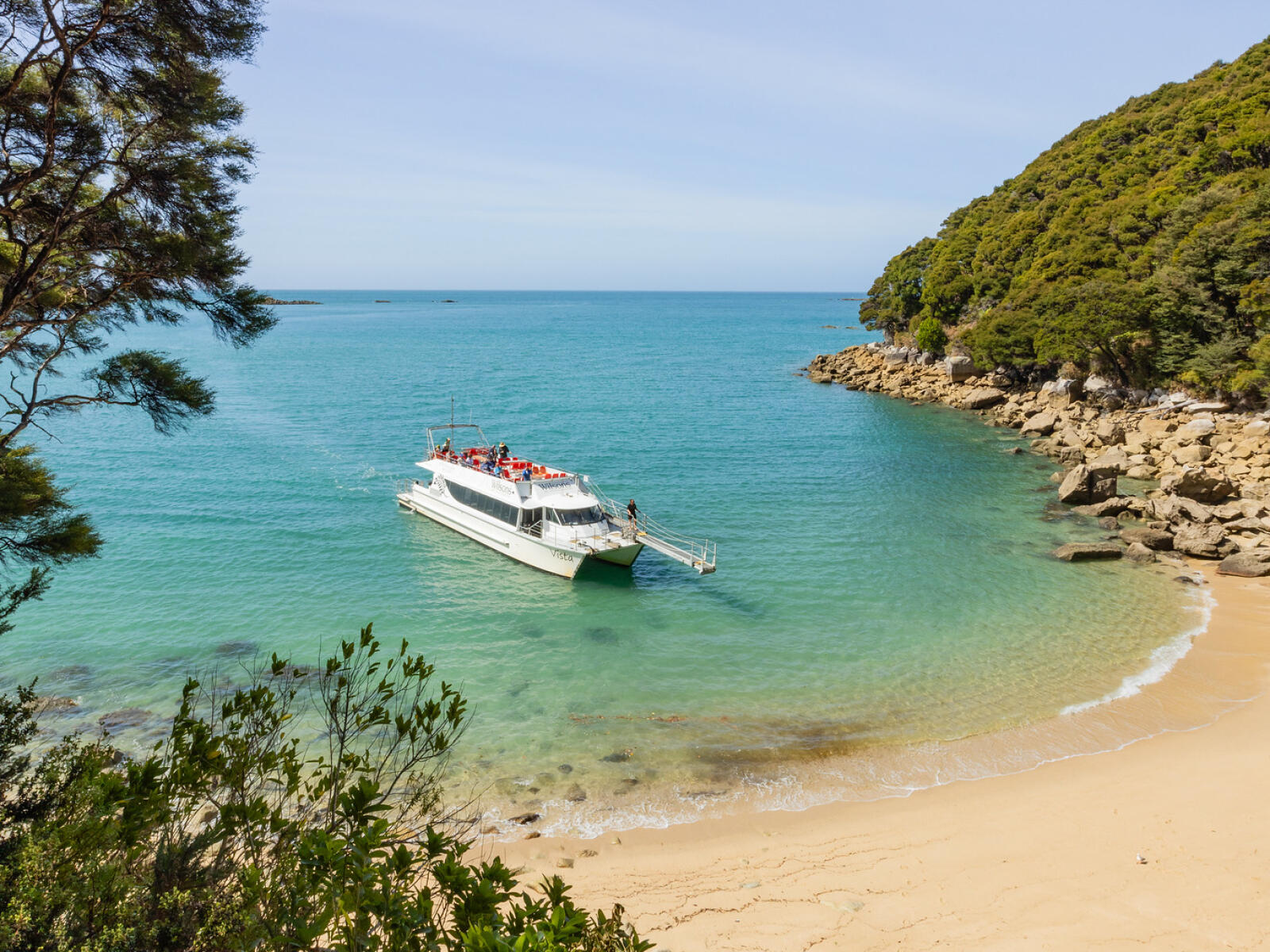 Walkers on the Abel Tasman Coast Track near Medlands Beach